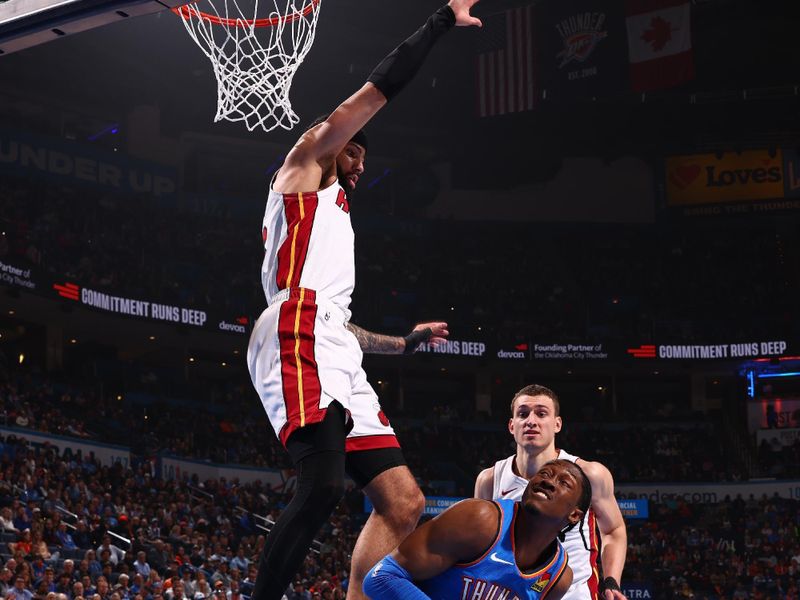 OKLAHOMA CITY, OK - MARCH 8:  Jalen Williams #8 of the Oklahoma City Thunder drives to the basket during the game as Caleb Martin #16 of the Miami Heat plays defense on March 8, 2024 at Paycom Arena in Oklahoma City, Oklahoma. NOTE TO USER: User expressly acknowledges and agrees that, by downloading and or using this photograph, User is consenting to the terms and conditions of the Getty Images License Agreement. Mandatory Copyright Notice: Copyright 2024 NBAE (Photo by Zach Beeker/NBAE via Getty Images)