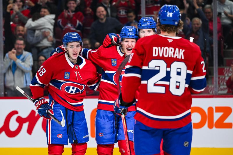 Oct 12, 2024; Montreal, Quebec, CAN; Montreal Canadiens left wing Emil Heineman (51) celebrates with defenseman Lane Hutson (48), center Christian Dvorak (28) and right wing Josh Anderson (17) after scoring his first NHL career goal against the Ottawa Senators during the first period at Bell Centre. Mandatory Credit: David Kirouac-Imagn Images