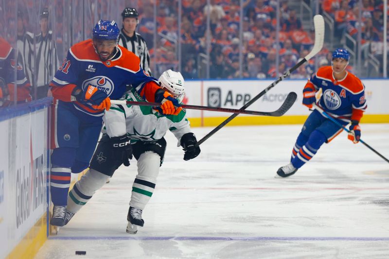 May 27, 2025; Edmonton, Alberta, CAN; Edmonton Oilers left wing Evander Kane (91) and Dallas Stars center Colin Blackwell (15) chase the puck during the first period in game four of the Western Conference Final of the 2025 Stanley Cup Playoffs at Rogers Place. Mandatory Credit: Perry Nelson-Imagn Images