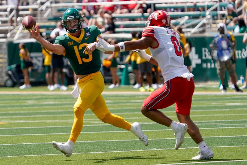 Sep 9, 2023; Waco, Texas, USA; Baylor Bears quarterback Sawyer Robertson (13) throws under pressure by Utah Utes defensive end Logan Fano (0) during the first half at McLane Stadium. Mandatory Credit: Raymond Carlin III-USA TODAY Sports