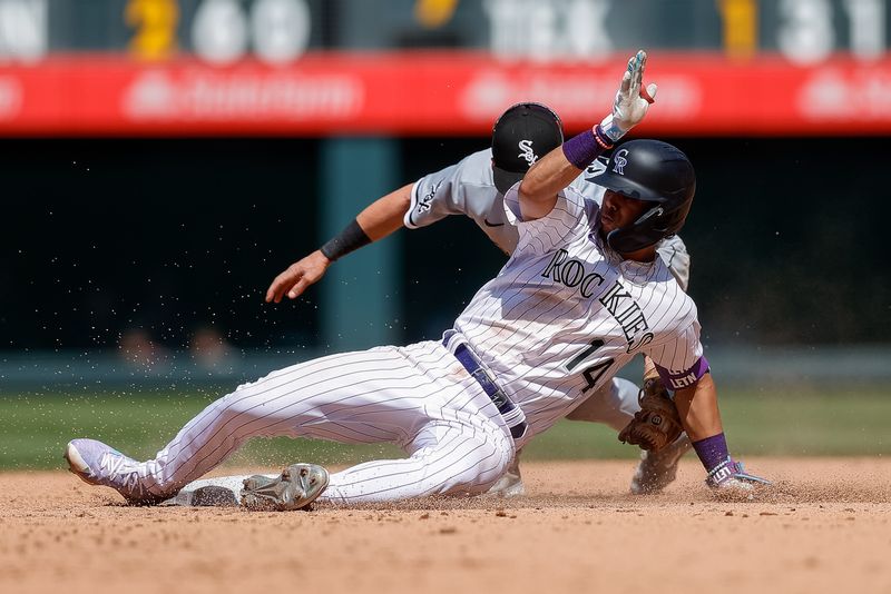 Aug 20, 2023; Denver, Colorado, USA; Colorado Rockies shortstop Ezequiel Tovar (14) is tagged out attempting to reach second on an RBI single against Chicago White Sox second baseman Zach Remillard (28) in the fifth inning at Coors Field. Mandatory Credit: Isaiah J. Downing-USA TODAY Sports