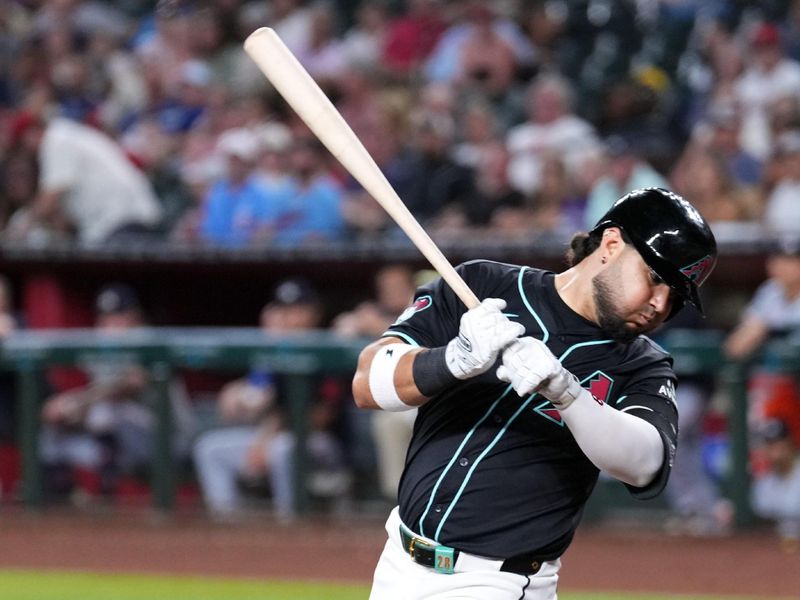 Jun 26, 2024; Phoenix, Arizona, USA; Arizona Diamondbacks third base Eugenio Suárez (28) stumbles as he strikes out against the Minnesota Twins during the fourth inning at Chase Field. Mandatory Credit: Joe Camporeale-USA TODAY Sports