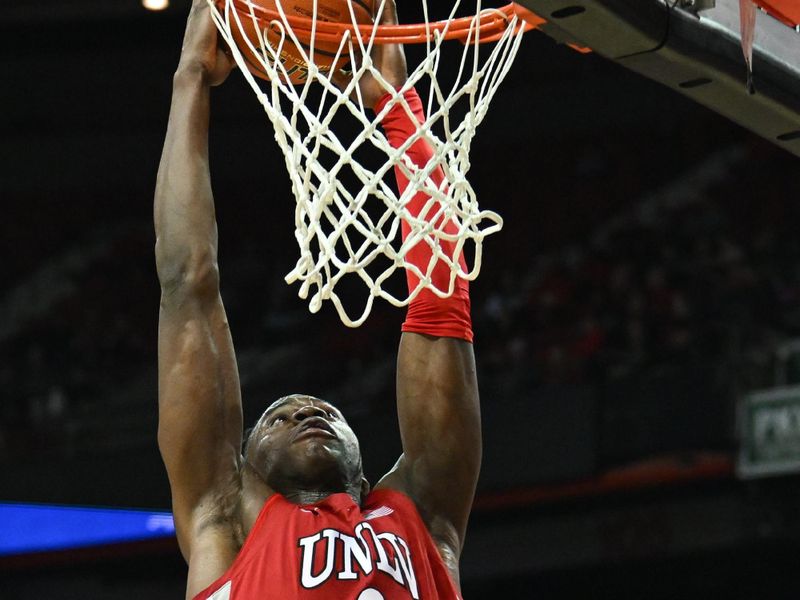 Jan 28, 2023; Las Vegas, Nevada, USA; UNLV Runnin' Rebels forward Victor Iwuakor (0) dunks the ball against the Nevada Wolf Pack in the second half at Thomas & Mack Center. Mandatory Credit: Candice Ward-USA TODAY Sports