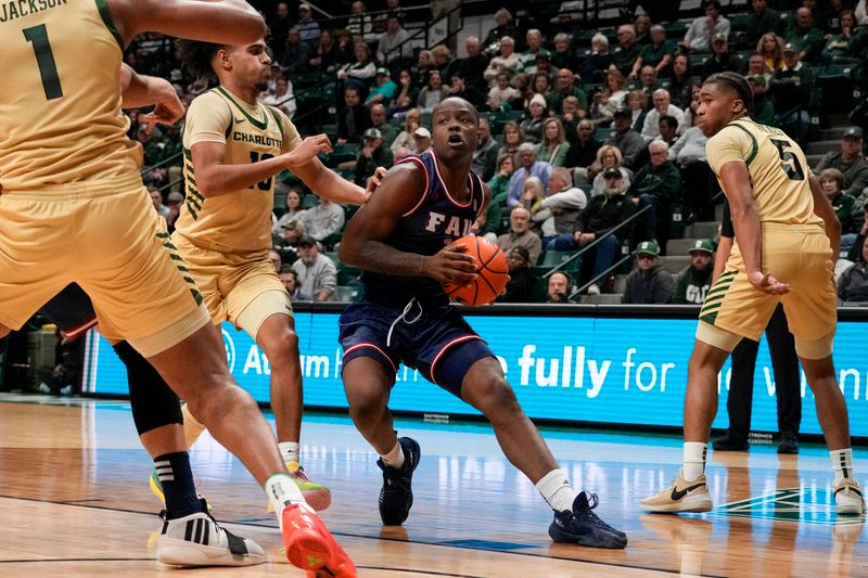 Jan 6, 2024; Charlotte, North Carolina, USA; Florida Atlantic Owls guard Johnell Davis (1) drives to the basket defended by Charlotte 49ers guard Nik Graves (10) and center Dishon Jackson (1) during the second half at Dale F. Halton Arena. Mandatory Credit: Jim Dedmon-USA TODAY Sports