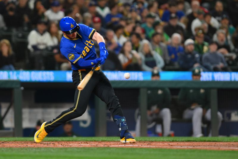 Sep 27, 2024; Seattle, Washington, USA; Seattle Mariners catcher Mitch Garver (18) hits a home run against the Oakland Athletics during the second inning at T-Mobile Park. Mandatory Credit: Steven Bisig-Imagn Images