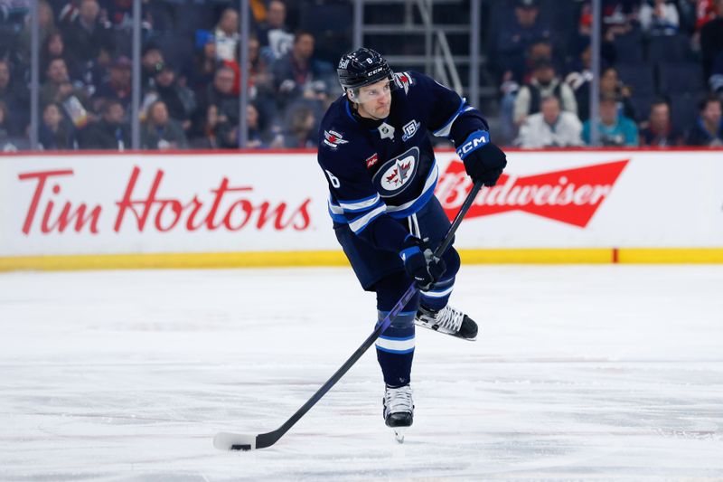 Apr 16, 2026; Winnipeg, Manitoba, CAN; Winnipeg Jets defenseman Colin Miller (6) shoots the puck into the San Jose Sharks zone during the second period at Canada Life Centre. Mandatory Credit: Terrence Lee-Imagn Images Apr 16, 2026; Winnipeg, Manitoba, CAN; Winnipeg Jets defenseman Colin Miller (6) shoots the puck into the San Jose Sharks zone during the second period at Canada Life Centre. Mandatory Credit: Terrence Lee-Imagn Images