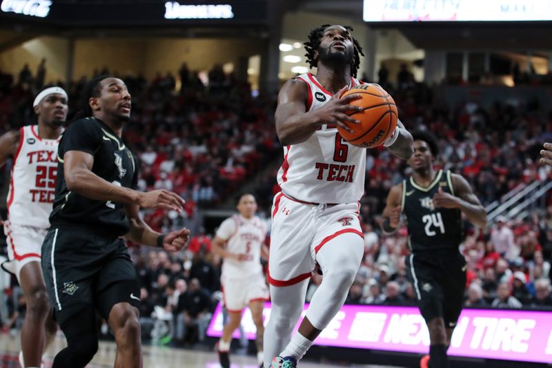 Feb 10, 2024; Lubbock, Texas, USA;  Texas Tech Red Raiders guard Joe Toussaint (6) goes to the basket against Central Florida Knights guard Shemarri Allen (2) in the first half United Supermarkets Arena. Mandatory Credit: Michael C. Johnson-USA TODAY Sports