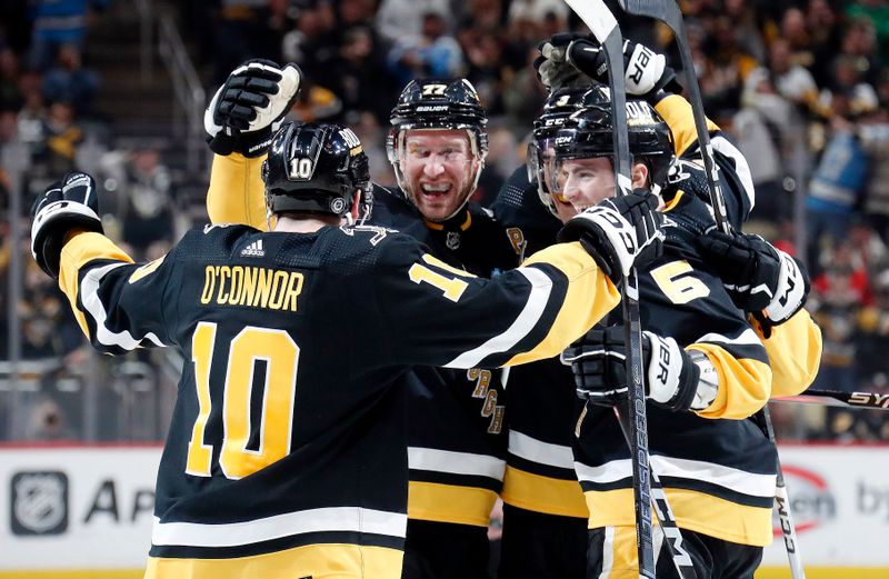 Apr 11, 2024; Pittsburgh, Pennsylvania, USA; Pittsburgh Penguins left wing Drew O'Connor (10) and defensemen Ryan Shea (5) and Jack St. Ivany (3) congratulate center Jeff Carter (77) on his short-handed goal against the Detroit Red Wings during the third period at PPG Paints Arena. Pittsburgh won 6-5 in overtime. Mandatory Credit: Charles LeClaire-USA TODAY Sports