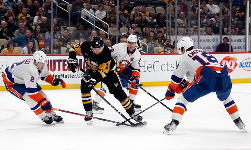 Feb 20, 2024; Pittsburgh, Pennsylvania, USA; New York Islanders defenseman Mike Reilly (2) and left wing Pierre Engvall (18) defend Pittsburgh Penguins left wing Drew O'Connor (10) during the third period at PPG Paints Arena. New York won 5-4 in overtime. Mandatory Credit: Charles LeClaire-USA TODAY Sports