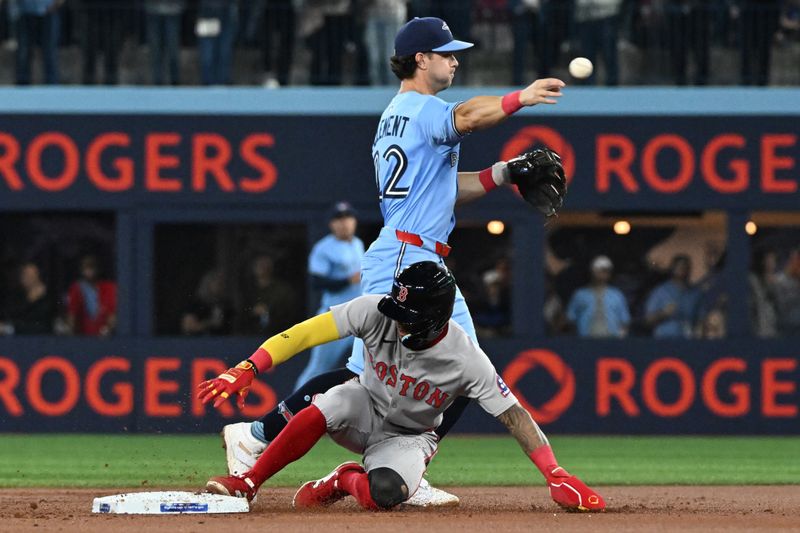 Sep 24, 2025; Toronto, Ontario, CAN;  Toronto Blue Jays shortstop Ernie Clement (22) forces out Boston Red Sox center fielder Cedanne Rafaela (3) but cannot turn a double play in the first inning at Rogers Centre. Mandatory Credit: Dan Hamilton-Imagn Images