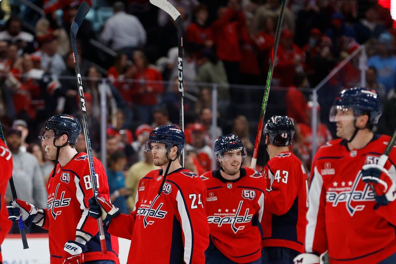 Nov 2, 2024; Washington, District of Columbia, USA; Washington Capitals center Connor McMichael (24) celebrates with teammates after their game against the Columbus Blue Jackets at Capital One Arena. Mandatory Credit: Geoff Burke-Imagn Images