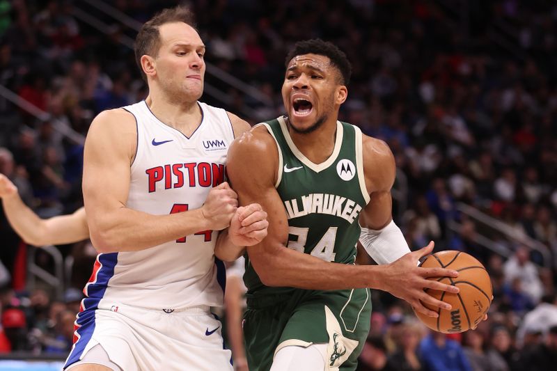 DETROIT, MICHIGAN - JANUARY 22: Giannis Antetokounmpo #34 of the Milwaukee Bucks drives to the basket against Bojan Bogdanovic #44 of the Detroit Pistons during the first half at Little Caesars Arena on January 22, 2024 in Detroit, Michigan. NOTE TO USER: User expressly acknowledges and agrees that, by downloading and or using this photograph, User is consenting to the terms and conditions of the Getty Images License  (Photo by Gregory Shamus/Getty Images)