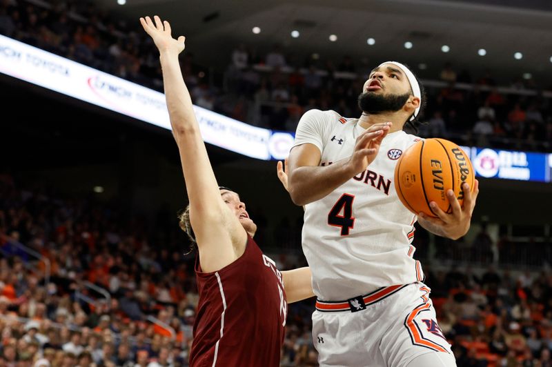 Dec 2, 2022; Auburn, Alabama, USA;  Auburn Tigers forward Johni Broome (4) gets past Colgate Raiders forward Keegan Records (14) for a shot during the second half at Neville Arena. Mandatory Credit: John Reed-USA TODAY Sports
