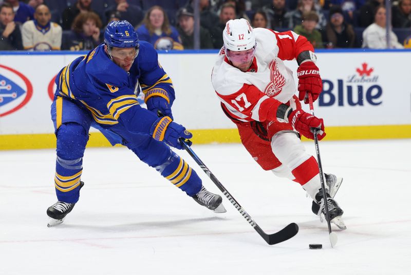 Dec 5, 2023; Buffalo, New York, USA;  Buffalo Sabres defenseman Erik Johnson (6) tries to defend as Detroit Red Wings right wing Daniel Sprong (17) skates with the puck during the first period at KeyBank Center. Mandatory Credit: Timothy T. Ludwig-USA TODAY Sports