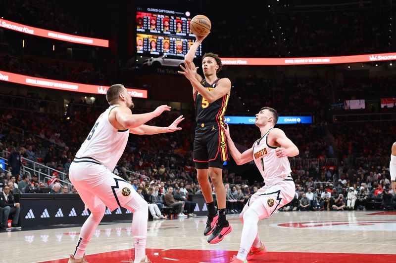 ATLANTA, GA - DECEMBER 8: Dyson Daniels #5 of the Atlanta Hawks shoots the ball during the game against the Denver Nuggets on December 8, 2024 at State Farm Arena in Atlanta, Georgia.  NOTE TO USER: User expressly acknowledges and agrees that, by downloading and/or using this Photograph, user is consenting to the terms and conditions of the Getty Images License Agreement. Mandatory Copyright Notice: Copyright 2024 NBAE (Photo by Adam Hagy/NBAE via Getty Images)