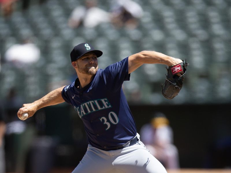 Jun 6, 2024; Oakland, California, USA; Seattle Mariners pitcher Austin Voth (30) delivers a pitch against the Oakland Athletics during the seventh inning at Oakland-Alameda County Coliseum. Mandatory Credit: D. Ross Cameron-USA TODAY Sports