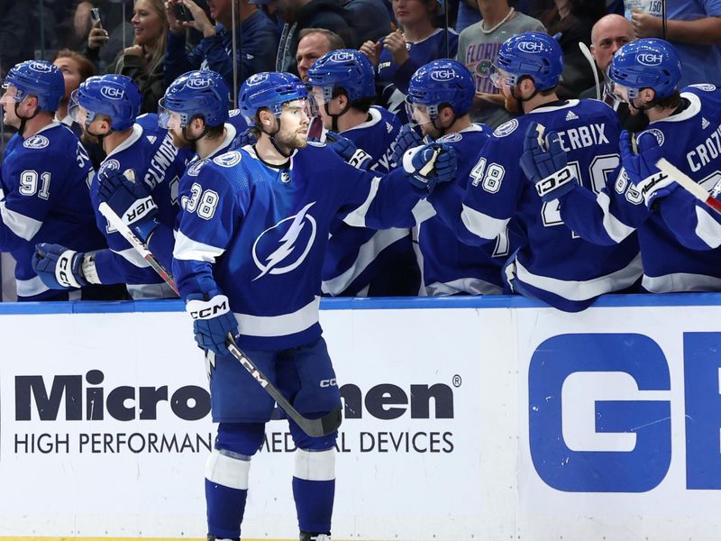 Jan 27, 2024; Tampa, Florida, USA; Tampa Bay Lightning left wing Brandon Hagel (38) is congratulated after he scored a goal against the New Jersey Devils during the second period at Amalie Arena. Mandatory Credit: Kim Klement Neitzel-USA TODAY Sports