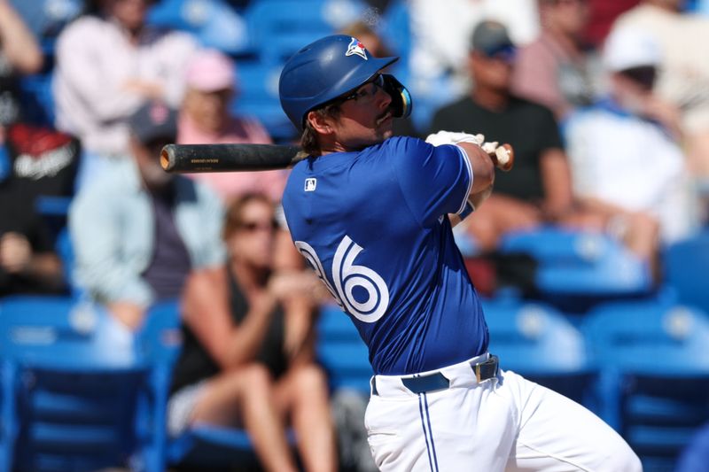 Mar 6, 2025; Dunedin, Florida, USA; Toronto Blue Jays outfielder Davis Schneider (36) hits an rbi single against the Boston Red Sox in the fourth inning during spring training at TD Ballpark. Mandatory Credit: Nathan Ray Seebeck-Imagn Images