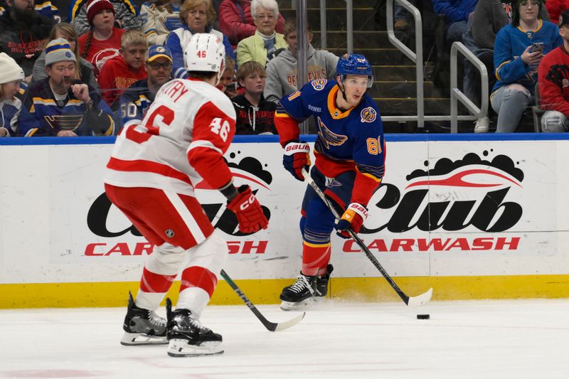 Apr 1, 2025; St. Louis, Missouri, USA; St. Louis Blues center Dylan Holloway (81) skates against the Detroit Red Wings during the second period at Enterprise Center. Mandatory Credit: Jeff Le-Imagn Images