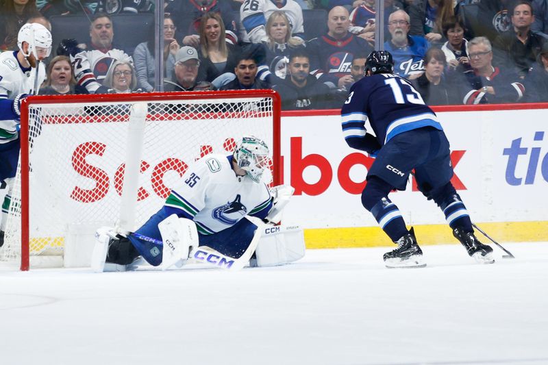 Apr 18, 2024; Winnipeg, Manitoba, CAN;  Winnipeg Jets forward Gabriel Vilardi (13) scores on Vancouver Canucks goalie Thatcher Demko (35) during the first period at Canada Life Centre. Mandatory Credit: Terrence Lee-USA TODAY Sports