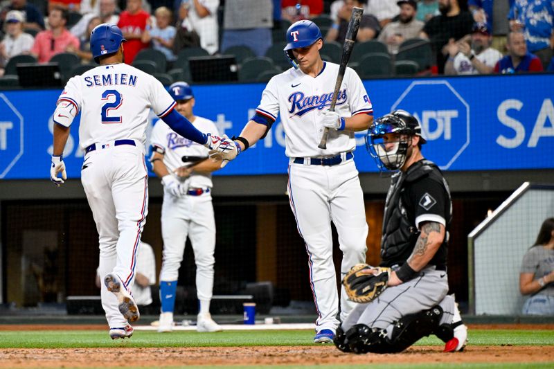 Aug 3, 2023; Arlington, Texas, USA; Texas Rangers second baseman Marcus Semien (2) and designated hitter Corey Seagar (5) celebrate after Semien hits a home run against the Chicago White Sox during the fourth inning at Globe Life Field. Mandatory Credit: Jerome Miron-USA TODAY Sports