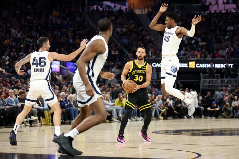 SAN FRANCISCO, CALIFORNIA - MARCH 20: Stephen Curry #30 of the Golden State Warriors looks to get a shot off on GG Jackson #45 of the Memphis Grizzlies in the first half at Chase Center on March 20, 2024 in San Francisco, California. NOTE TO USER: User expressly acknowledges and agrees that, by downloading and or using this photograph, User is consenting to the terms and conditions of the Getty Images License Agreement.  (Photo by Ezra Shaw/Getty Images)