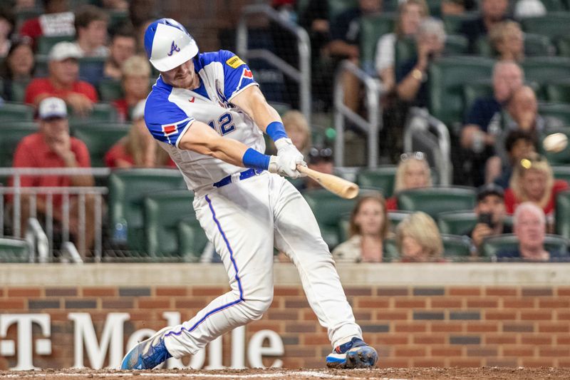 Sep 9, 2023; Cumberland, Georgia, USA; Atlanta Braves catcher Sean Murphy (12) hits single against Pittsburgh Pirates during seventh inning at Truist Park. Mandatory Credit: Jordan Godfree-USA TODAY Sports