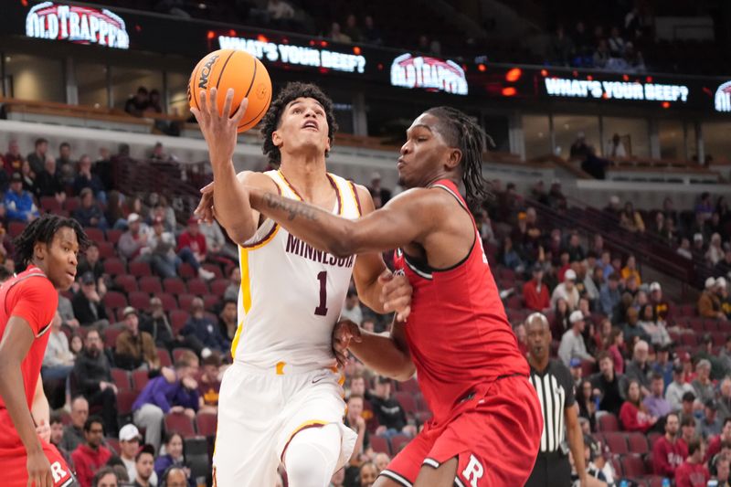 Mar 11, 2026; Chicago, IL, USA; Minnesota Golden Gophers guard Isaac Asuma (1) is defended by Rutgers Scarlet Knights guard Darren Buchanan Jr. (5) during the first half at United Center. Mandatory Credit: David Banks-Imagn Images