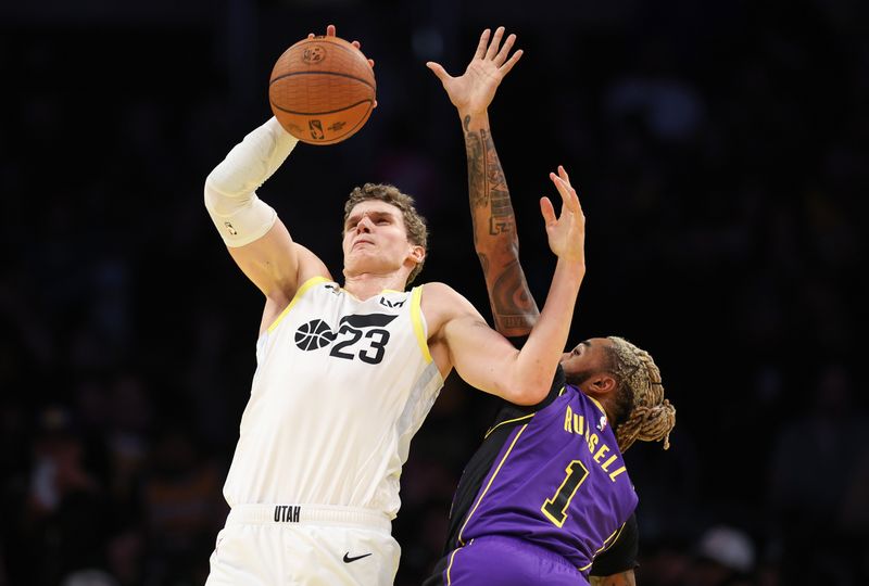 LOS ANGELES, CALIFORNIA - NOVEMBER 19: Lauri Markkanen #23 of the Utah Jazz catches a pass as he is fouled by D'Angelo Russell #1 of the Los Angeles Lakers during the second quarter of the Emirates NBA Cup at Crypto.com Arena on November 19, 2024 in Los Angeles, California. NOTE TO USER: User expressly acknowledges and agrees that, by downloading and or using this photograph, User is consenting to the terms and conditions of the Getty Images License Agreement.  (Photo by Harry How/Getty Images)