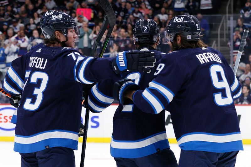 Mar 11, 2024; Winnipeg, Manitoba, CAN; Winnipeg Jets right wing Tyler Toffoli (73) celebrates the second period goal by Winnipeg Jets left wing Alex Iafallo (9) against the Washington Capitals at Canada Life Centre. Mandatory Credit: James Carey Lauder-USA TODAY Sports