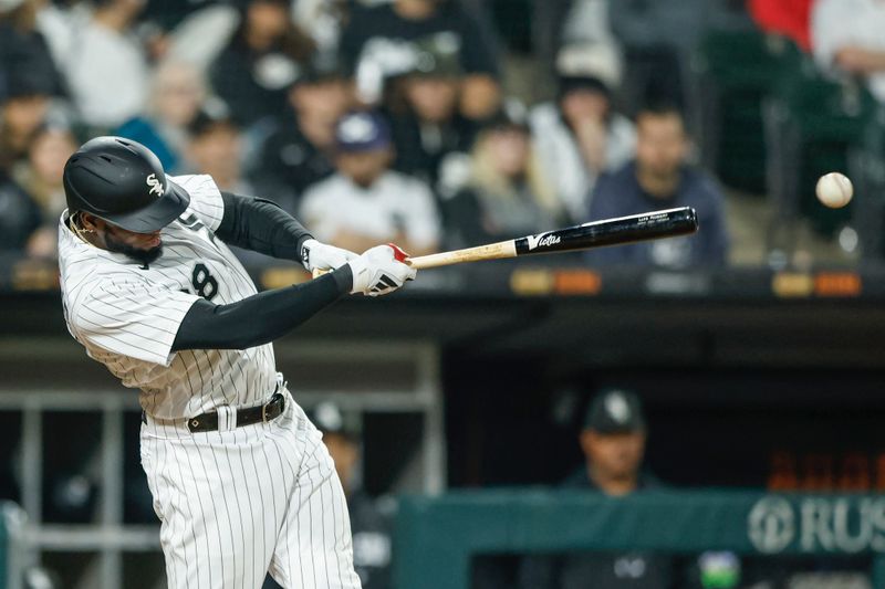 May 13, 2023; Chicago, Illinois, USA; Chicago White Sox center fielder Luis Robert Jr. (88) hits an RBI-single against the Houston Astros during the eighth inning at Guaranteed Rate Field. Mandatory Credit: Kamil Krzaczynski-USA TODAY Sports
