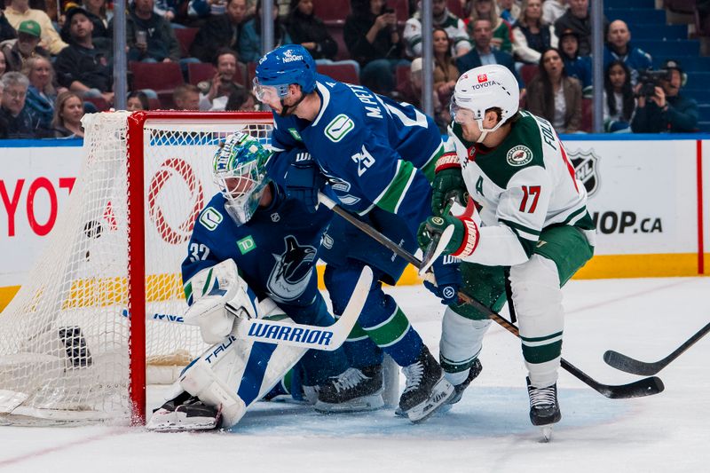 Apr 12, 2025; Vancouver, British Columbia, CAN; Vancouver Canucks defenseman Marcus Pettersson (29) watches as Minnesota Wild forward Marcus Foligno (17) scores on goalie Kevin Lankinen (32) in the third period at Rogers Arena. Mandatory Credit: Bob Frid-Imagn Images