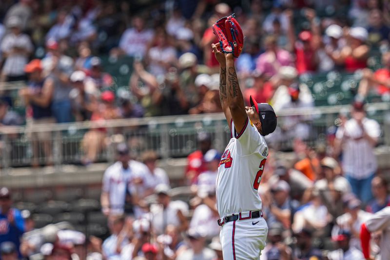 May 15, 2025; Cumberland, Georgia, USA; Atlanta Braves pitcher Raisel Iglesias (26) reacts after the final out against the Washington Nationals during the ninth inning at Truist Park. Mandatory Credit: Dale Zanine-Imagn Images