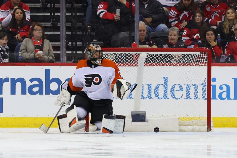 Jan 18, 2025; Newark, New Jersey, USA; Philadelphia Flyers goaltender Samuel Ersson (33) makes a save against the New Jersey Devils during the third period at Prudential Center. Mandatory Credit: Ed Mulholland-Imagn Images