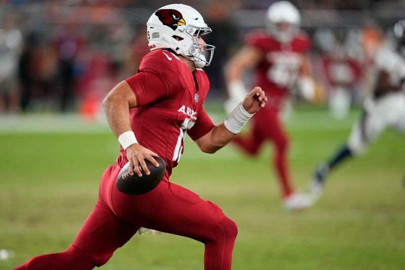 Arizona Cardinals quarterback Clayton Tune runs with the ball against the Denver Broncos during the second half of an NFL preseason football game, Friday, Aug. 11, 2023, in Glendale, Ariz. (AP Photo/Ross D. Franklin)