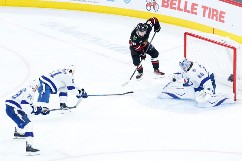 Jan 23, 2026; Chicago, Illinois, USA; Tampa Bay Lightning goaltender Andrei Vasilevskiy (88) defends against Chicago Blackhawks center Connor Bedard (98) during the second period at United Center. Mandatory Credit: Kamil Krzaczynski-Imagn Images