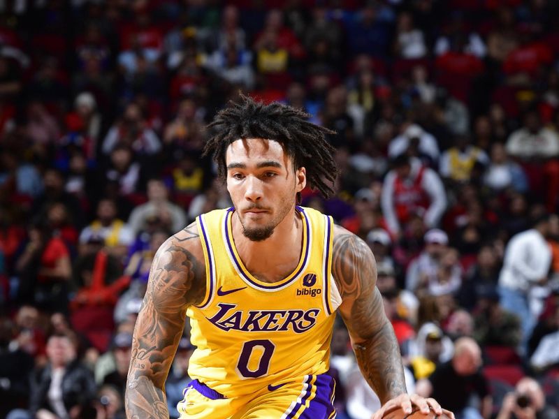 HOUSTON, TX - JANUARY 29:  Jalen Hood-Schifino #0 of the Los Angeles Lakers  dribbles the ball during the game against the Houston Rockets on January 29, 2024 at the Toyota Center in Houston, Texas. NOTE TO USER: User expressly acknowledges and agrees that, by downloading and or using this photograph, User is consenting to the terms and conditions of the Getty Images License Agreement. Mandatory Copyright Notice: Copyright 2024 NBAE (Photo by Logan Riely/NBAE via Getty Images)