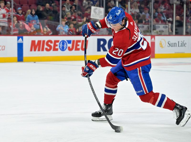 Apr 6, 2024; Montreal, Quebec, CAN; Montreal Canadiens forward Juraj Slafkovsky (20) takes a shot during the warmup period before the game against the Toronto Maple Leafs at the Bell Centre. Mandatory Credit: Eric Bolte-USA TODAY Sports