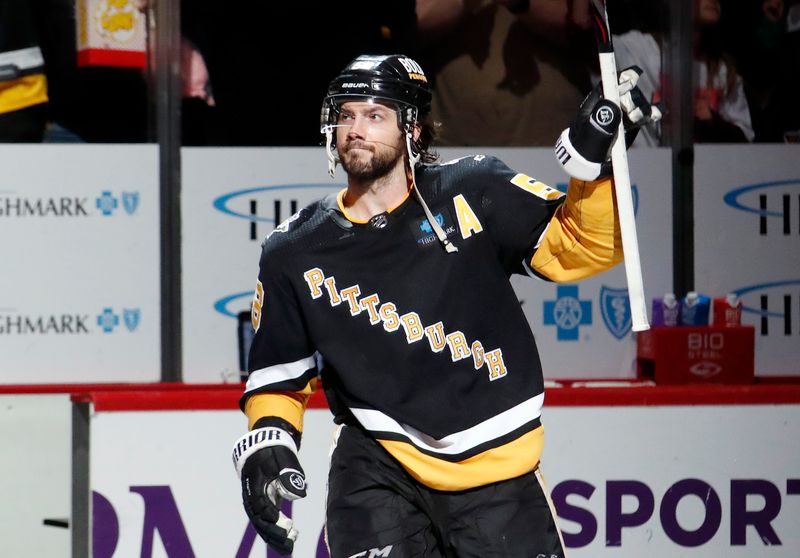 Apr 6, 2023; Pittsburgh, Pennsylvania, USA; Pittsburgh Penguins defenseman Kris Letang (58) to the crowd reacts after being named first star of the game and defeating the Minnesota Wild at PPG Paints Arena. Pittsburgh won 4-1. Mandatory Credit: Charles LeClaire-USA TODAY Sports