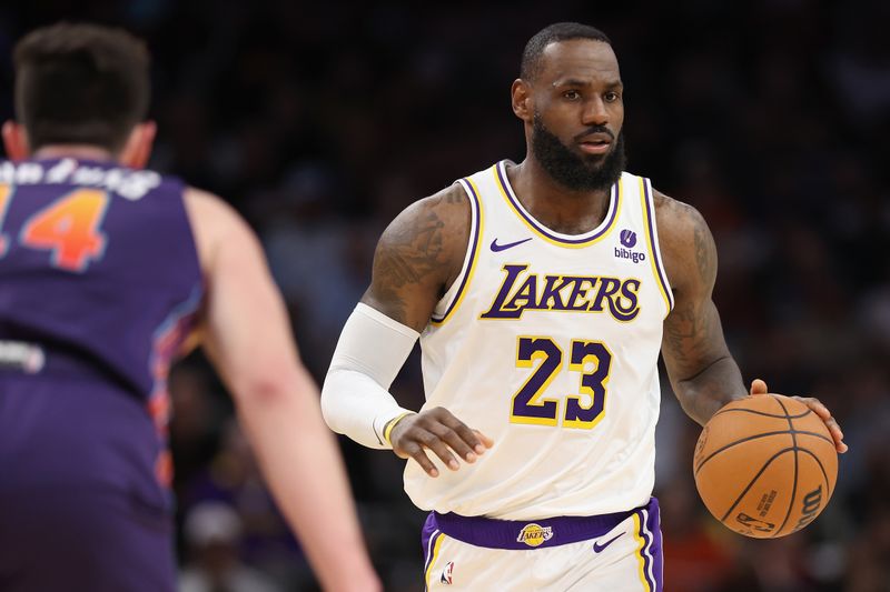 PHOENIX, ARIZONA - FEBRUARY 25: LeBron James #23 of the Los Angeles Lakers handles the ball against the Phoenix Suns during the first half of the NBA game at Footprint Center on February 25, 2024 in Phoenix, Arizona. NOTE TO USER: User expressly acknowledges and agrees that, by downloading and or using this photograph, User is consenting to the terms and conditions of the Getty Images License Agreement.  (Photo by Christian Petersen/Getty Images)