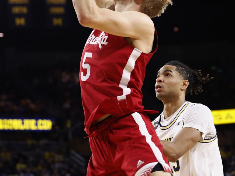 Feb 8, 2023; Ann Arbor, Michigan, USA;  Nebraska Cornhuskers guard Sam Griesel (5) shoots on Michigan Wolverines guard Jett Howard (13) in the second half at Crisler Center. Mandatory Credit: Rick Osentoski-USA TODAY Sports