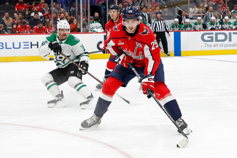 Oct 17, 2024; Washington, District of Columbia, USA; Washington Capitals center Hendrix Lapierre (29) skates with the puck as Dallas Stars center Sam Steel (18) chases in the first period at Capital One Arena. Mandatory Credit: Geoff Burke-Imagn Images