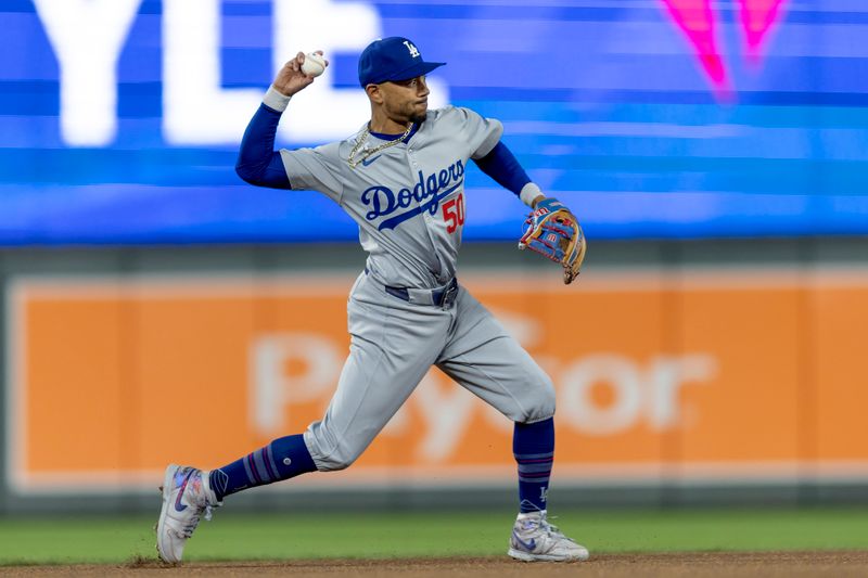 Apr 9, 2024; Minneapolis, Minnesota, USA; Los Angeles Dodgers shortstop Mookie Betts (50) throws the ball to first base for an out against the Minnesota Twins in the ninth inning at Target Field. Mandatory Credit: Jesse Johnson-USA TODAY Sports