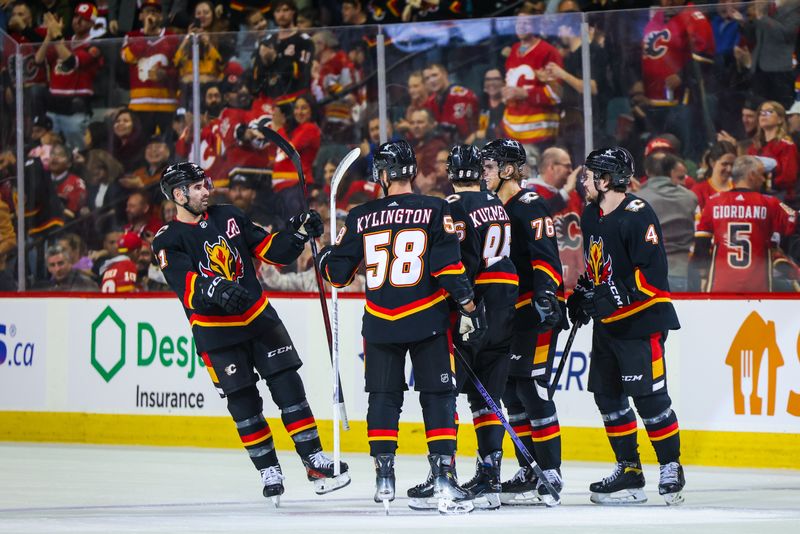 Apr 2, 2024; Calgary, Alberta, CAN; Calgary Flames left wing Andrei Kuzmenko (96) celebrates his goal with teammates against the Anaheim Ducks during the second period at Scotiabank Saddledome. Mandatory Credit: Sergei Belski-USA TODAY Sports