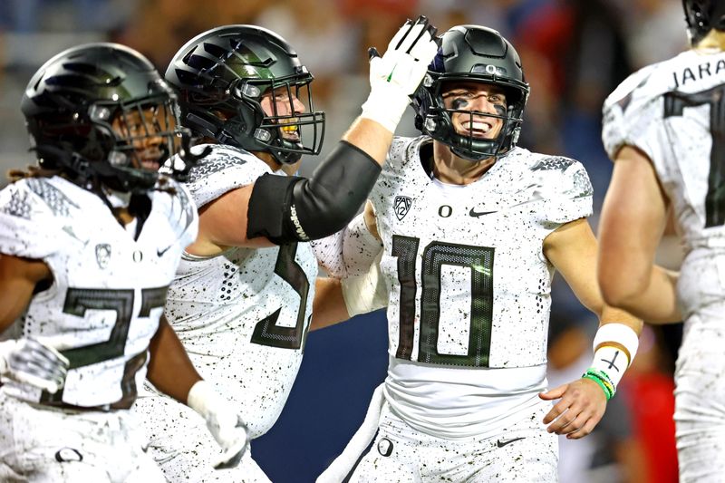 Oct 8, 2022; Tucson, Arizona, USA; Oregon Ducks quarterback Bo Nix (10) celebrates scoring a touchdown during the second half against the Arizona Wildcats at Arizona Stadium. Mandatory Credit: Mark J. Rebilas-USA TODAY Sports