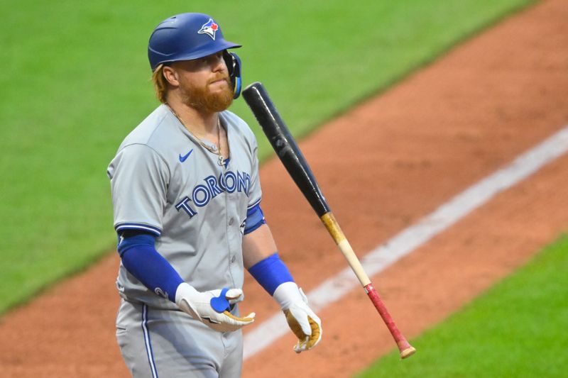 Jun 21, 2024; Cleveland, Ohio, USA; Toronto Blue Jays designated hitter Justin Turner (2) tosses his bat after striking out in the sixth inning against the Cleveland Guardians at Progressive Field. Mandatory Credit: David Richard-USA TODAY Sports