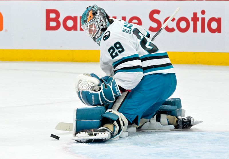 Jan 11, 2024; Montreal, Quebec, CAN; San Jose Sharks goalie Mackenzie Blackwood (29) makes a save against the Montreal Canadiens during the first period at the Bell Centre. Mandatory Credit: Eric Bolte-USA TODAY Sports