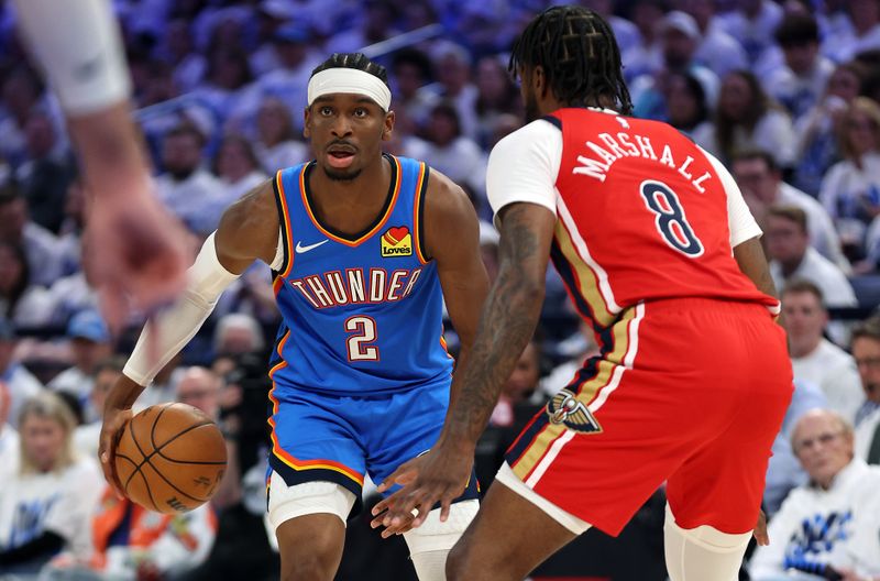 OKLAHOMA CITY, OKLAHOMA - APRIL 24:  Shai Gilgeous-Alexander #2 of the Oklahoma City Thunder controls the ball as Naji Marshall #8 of the New Orleans Pelicans defends during game two of the first round of the NBA playoffs at Paycom Center on April 24, 2024 in Oklahoma City, Oklahoma. (Photo by Jamie Squire/Getty Images)