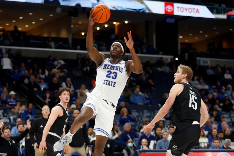 Jan 31, 2024; Memphis, Tennessee, USA; Memphis Tigers forward Malcolm Dandridge (23) drives to the basket as Rice Owls forward Max Fiedler (15) defends during the first half at FedExForum. Mandatory Credit: Petre Thomas-USA TODAY Sports