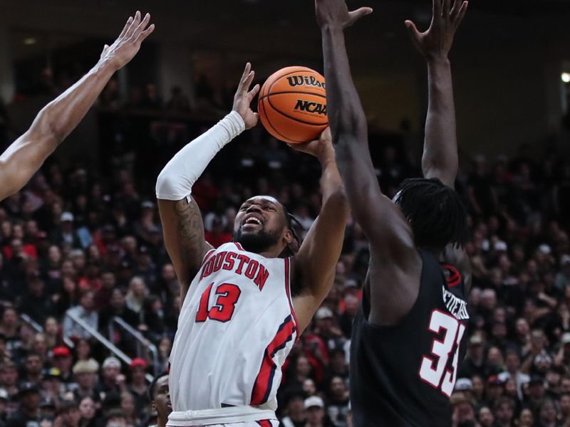 Feb 24, 2025; Lubbock, Texas, USA;  Houston Cougars forward J’Wan Roberts (13) shoots against Texas Tech Red Raiders forward Federiko Federiko (33) in the first half at United Supermarkets Arena. Mandatory Credit: Michael C. Johnson-Imagn Images